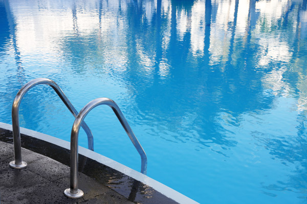 swimming pool ladder and blue water swimming pool
